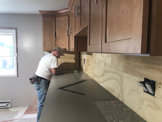 Installation of a complete new custom kitchen, designed and installed from the studs out included electrical, plumbing, cabinets, & flooring