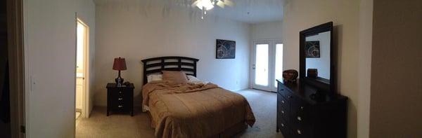 Masterbedroom, doors to railing-ed in outdoor patio.