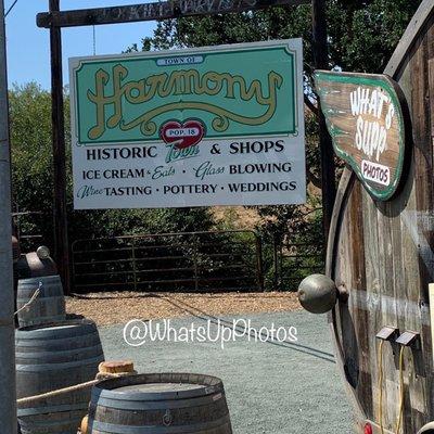 Dolores the rustic photo booth trailer posing next to the iconic sign pre wedding in Harmony CA @WhatsUpPhotos