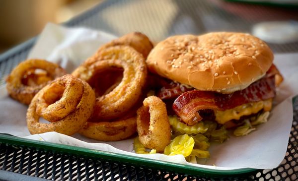 Bacon cheese burger with a side of onion rings