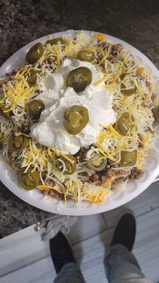 Nachos with doritos, ground beef cheese, sour cream and mild peppers and also walking Nachos