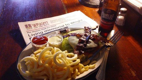 Bacon and blue cheese burger with curly fries.