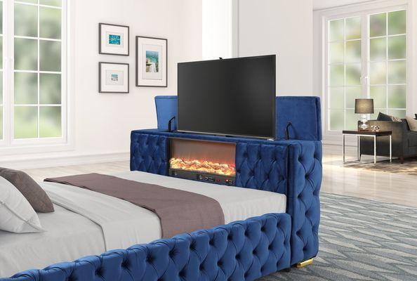 bed with a built-in fireplace in the footboard, accompanied by a convenient TV stand