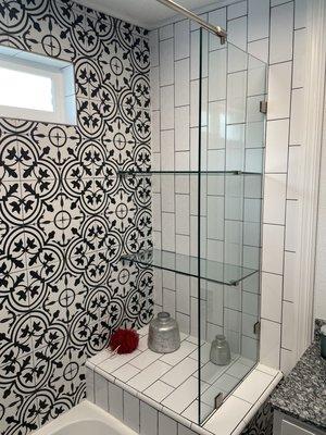 Frameless shelves connected to a frameless shower panel