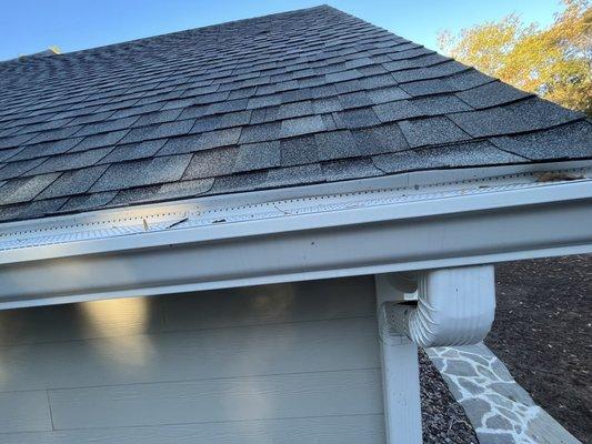 Drip Edge installed too high pushing up the shingles causing water to flow behind the gutters