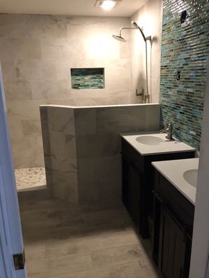 Completely resigned full bathroom remodel. The unique shower, and transparent glass tile accents really set this bathroom apart.