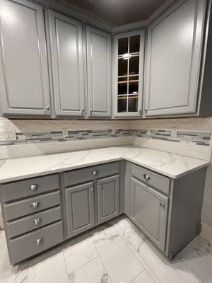 Paint cabinet, install new floor, counter top, tile backsplash and electrical