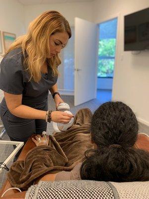 Nurse Jenny setting up a patient with noise cancelling headphones