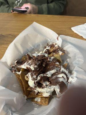 Chips with refried beans and cotija