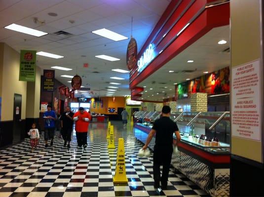 Buffet area with salad, pizza, baked potatoes, nachos, hotdogs, soup, and desserts