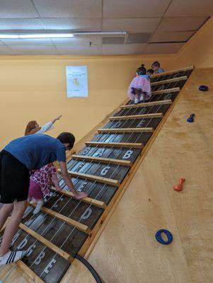 Giant realistic guitar slide climbing wall