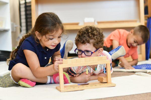 West Side Montessori students working with math materials.