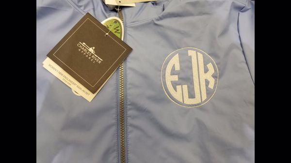 Monogrammed Charles river reflective new englander per wrinkle full zip rain jacket with natural circle monogram w/ border.