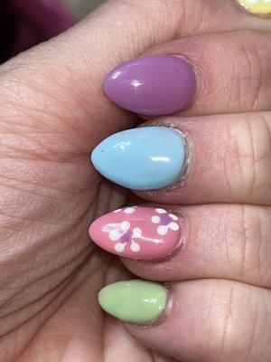 The pink nail was the cuticle covered in polish. You can tell with the blue also that cuticle care wasn't thought about.