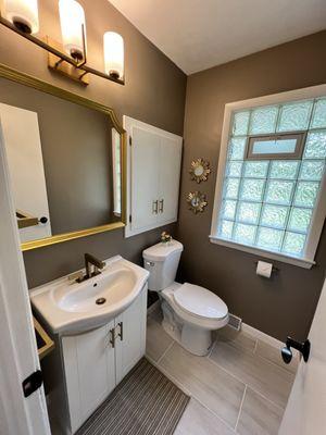 .5 bath design and install by Maeko. Paint, drywall, light fixture, mirror, vanity, window, flooring, trim, hardware install.