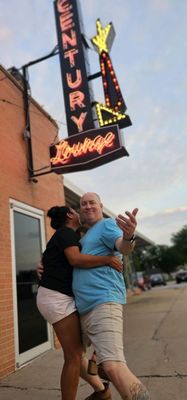 My bruh n his wife having fun in front of this chill bar.