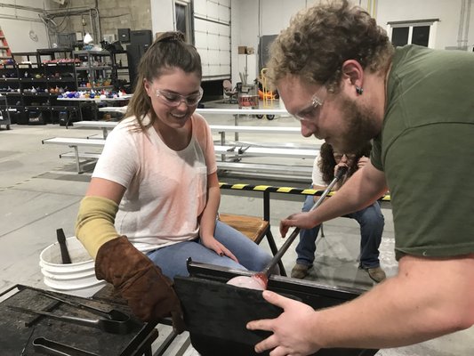 Adam of Neusole Glassworks helping daughter to make a floppy bowl