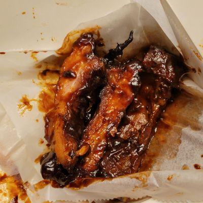 3 ribs, drenched in bbq sauce