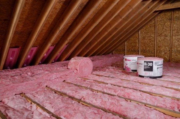 Fiberglass insulation installed in attic are