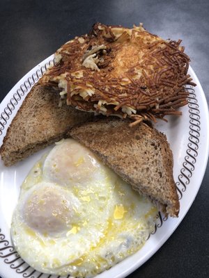 Eggs over easy, wheat toast, double hash brown smothered peppered & scattered well done.