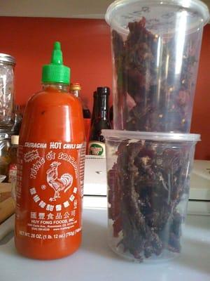 $13.00 per/lb but look at how much jerky a lb really is (next to a 28 ounce bottle of Siracha to show scale)