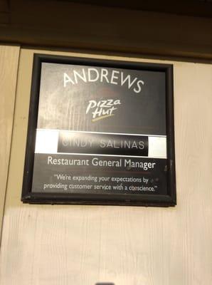 Store sign that shows who the general manager of the store is