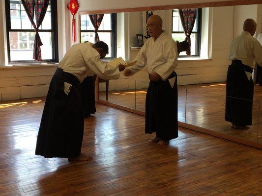 Head Instructor Shaffee Sensei accepts rank from Kaiso.