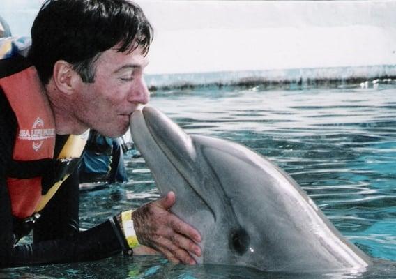 Dr. Melese getting a kiss from an aquatic friend.