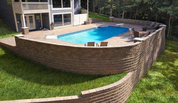 Allan Block retaining & seat walls surround a beautiful concrete paver patio.