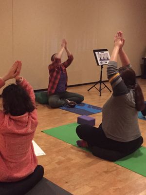 Hannah Gould teaching students in the Friday night yoga for Autism class at TriYoga in Waltham, MA.