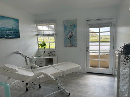 Clean and serene spa treatment room/space.