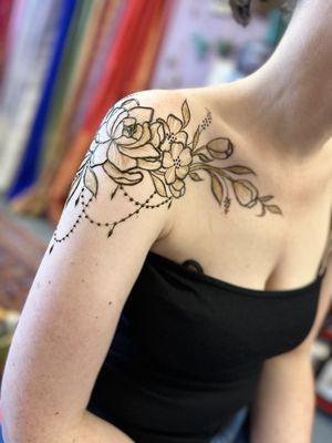 Delicate floral henna wrapping from back to shoulder to chest.