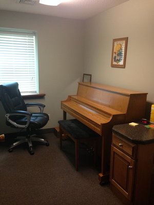 One of our piano and string rooms, which houses an upright piano.