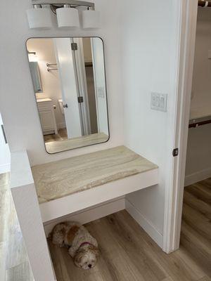 Vanity area (Emerson) after.

New textured ceiling, paint, flooring, baseboards, mirror, lights, counter and outlets.