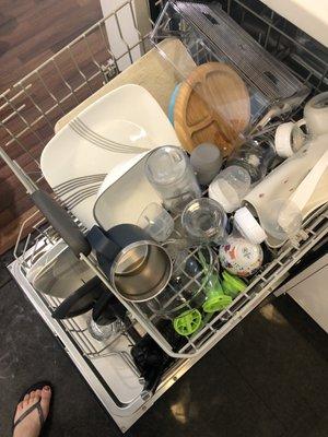 Baby bottles, dishes, cast iron, cups, mugs all in one. See the way she put the mug?