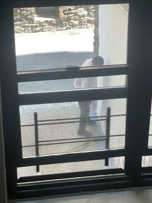 Man urinating on apartment building