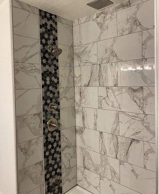 Tile shower with 3 shower heads.