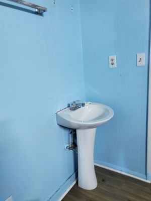 A sink in the corner of the room