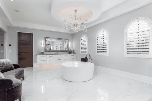 O'Hair Wood Shutter in a gorgeous Master Bathroom, with an arched top, in a 4" louver with the hidden tilt rod feature.