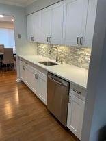 New flooring, new kitchen cabinets with undermounted lights.