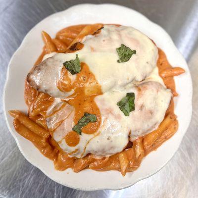 Drunk Chicken Dinner. Chicken Cutlets over Pasta smothered in Vodka Sauce and finished with Fresh Mozzarella and Basil