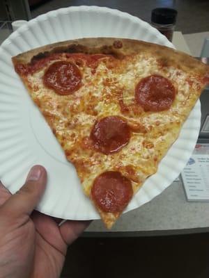 Hot and fresh slice of pepperoni pizza.