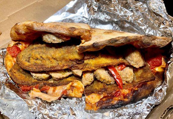 Pizza sandwich-breaded eggplant,meatballs,onions,bell peppers,tomato chunks & cheese in fresh baked, crispy personal pizza crust - awesome!