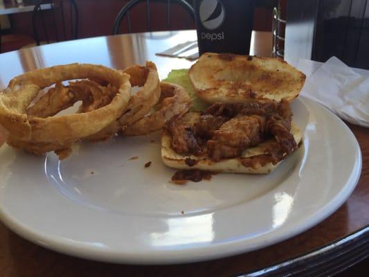 Pulled pork sandwich and onion rings.