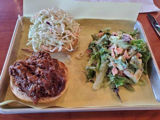 Bbq Brisket sandwich with slaw and a side salad.