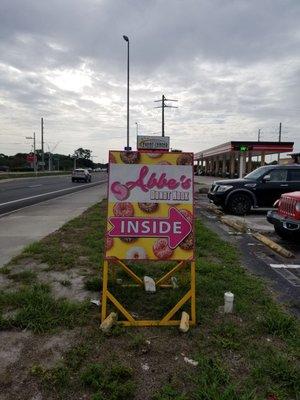 Small sign by the street helps you find the storefront.