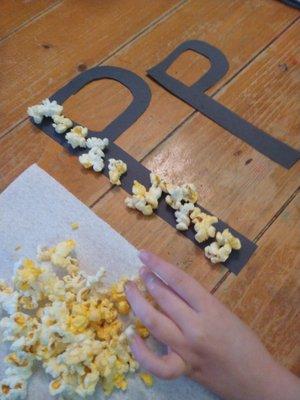 Tracing letters with popcorn!