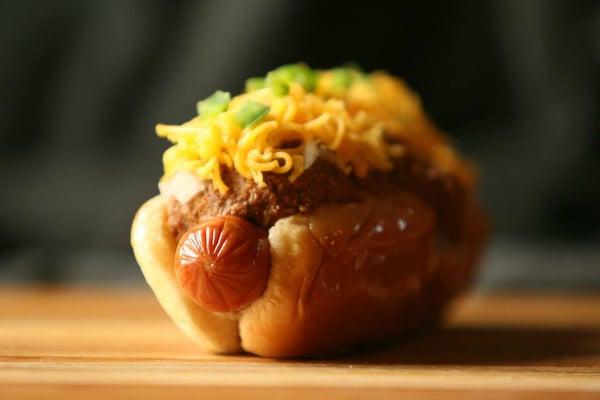 Coney Island - All natural 100% beef dog, covered with Hills chili, and topped with diced onions and fresh cheddar cheese