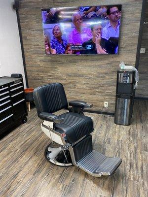 Barber chair and TV in the back