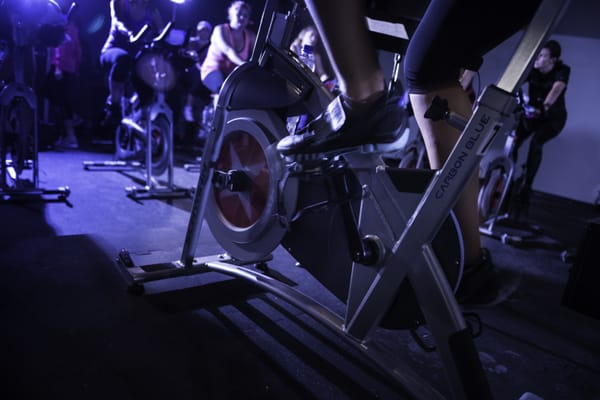 High energy classes under black lights in a candle-lit studio